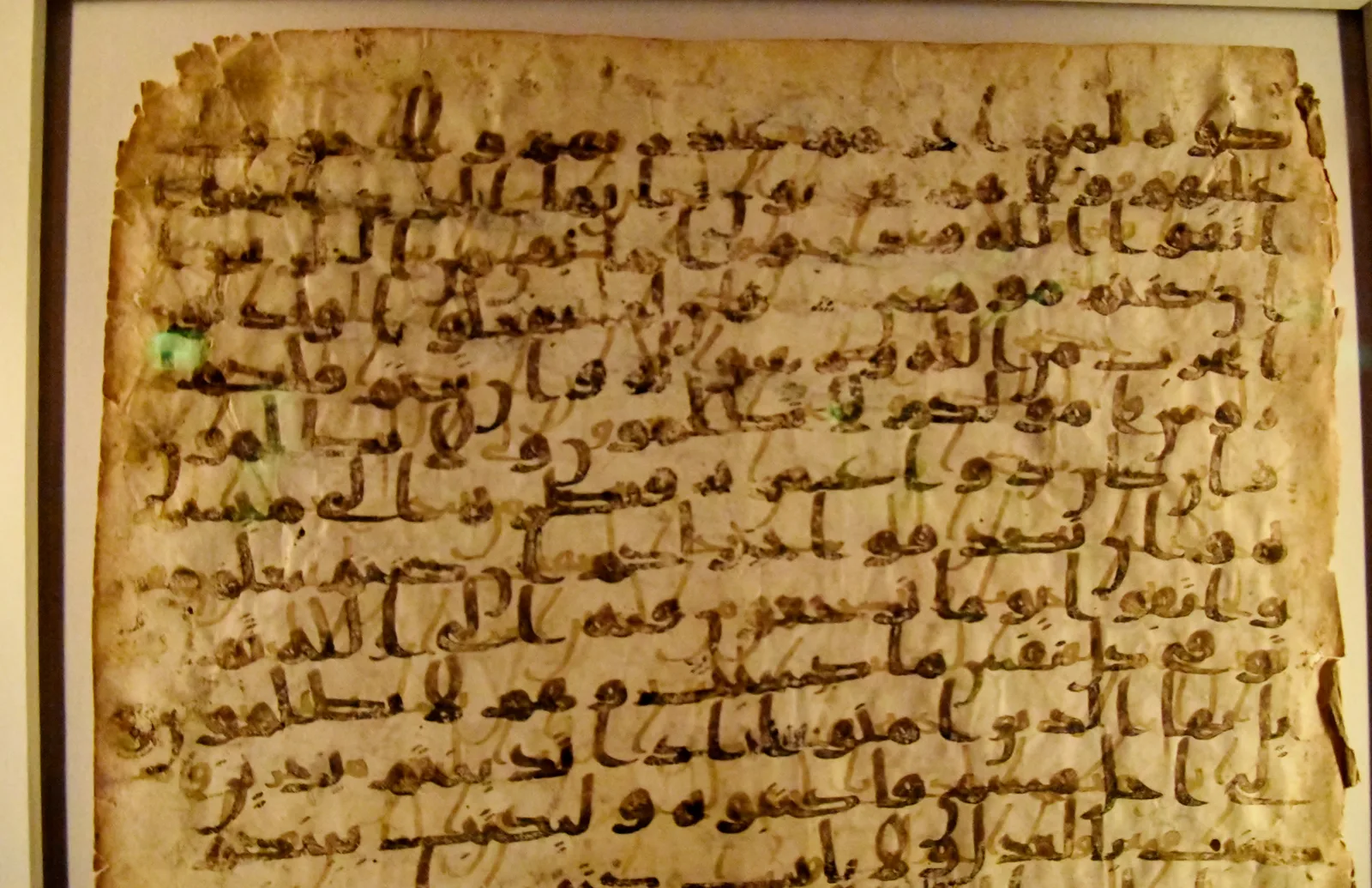 Seventh-century parchment leaf with upper and reemerged lower Quranic writing layers